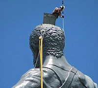 Man applying coat to Birmingham’s Vulcan statue.