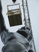 Ground shot of Birmingham’s Vulcan statue being applied with protective coating.